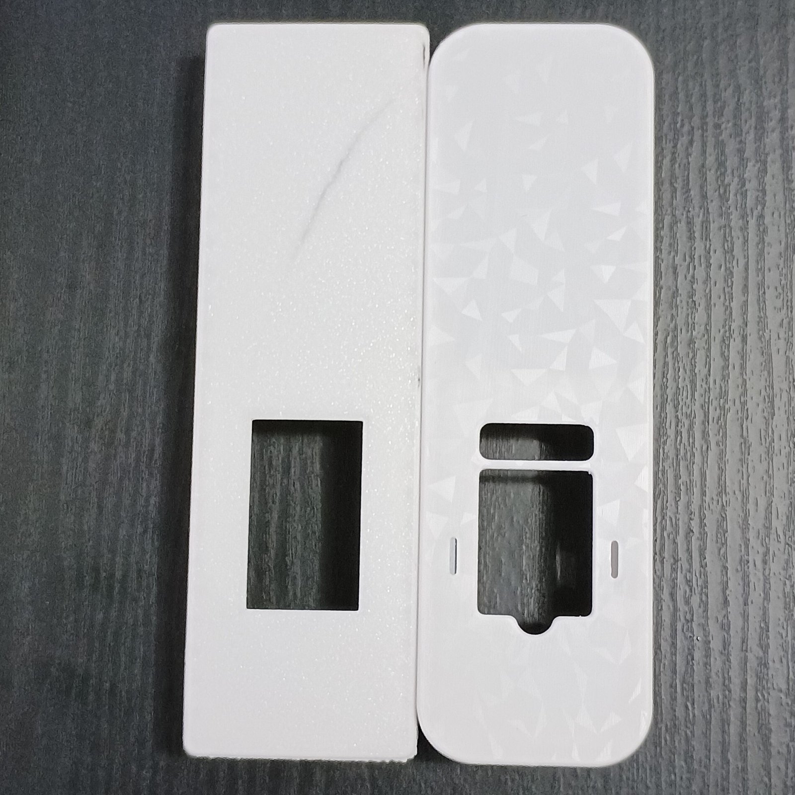 Two white radiator meter cover prototypes shown side by side.