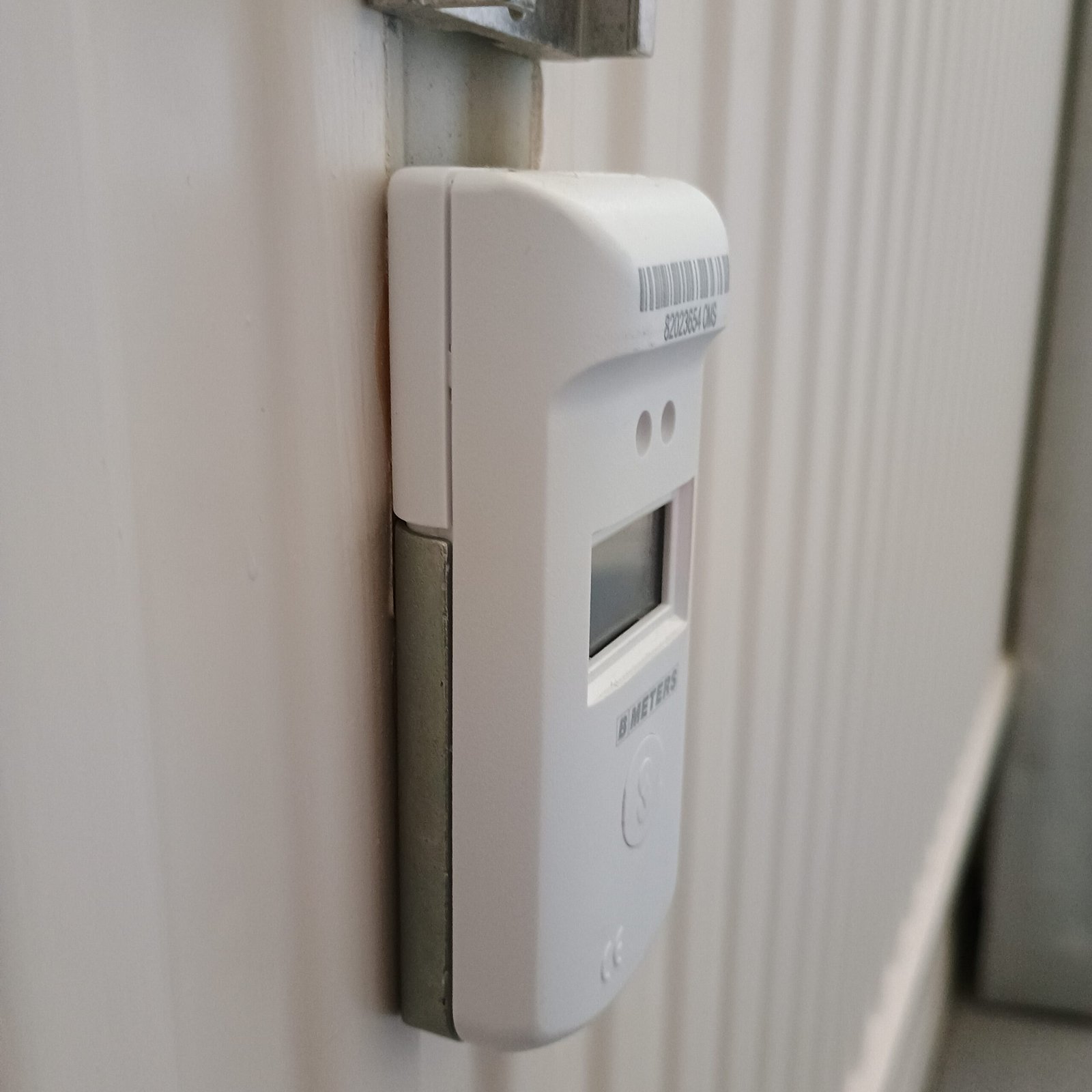 Underside view of a fitted cover beneath the existing metal bracket.