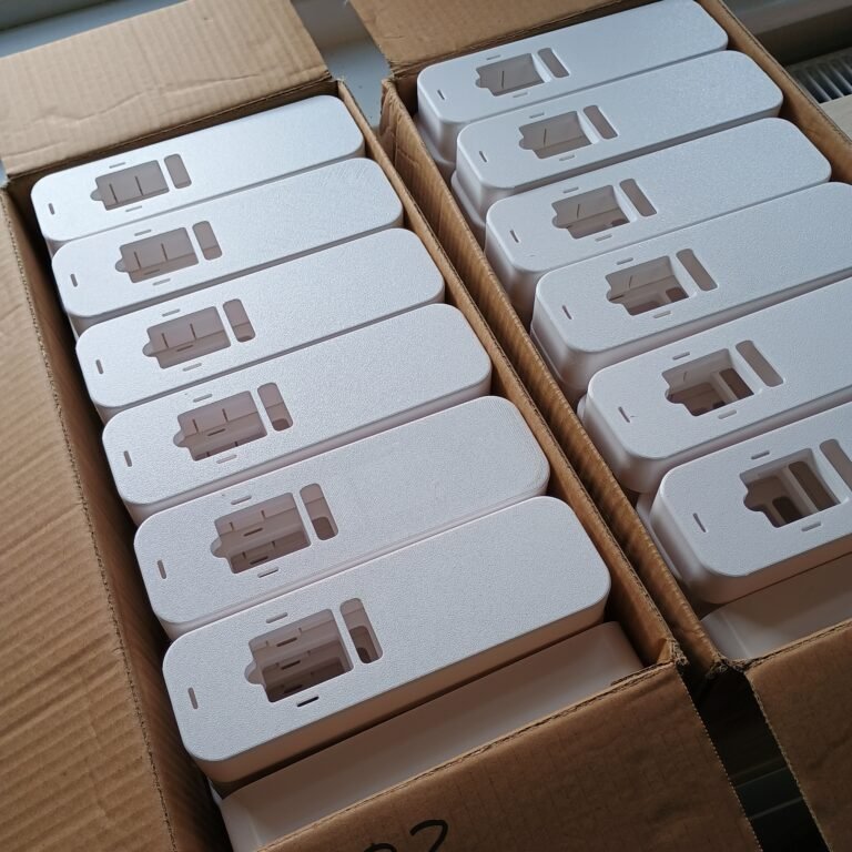 White PETG radiator meter covers arranged in production boxes.