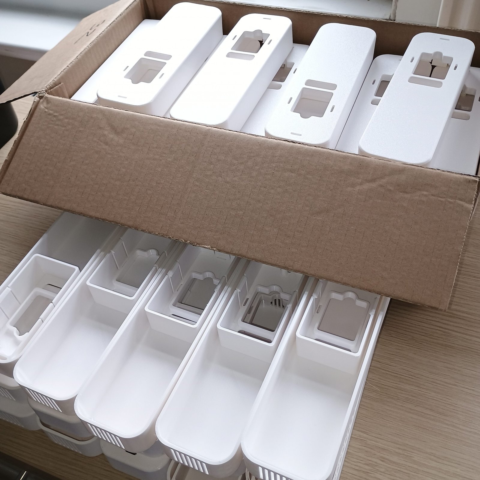White PETG covers showing the internal geometry of the production parts.